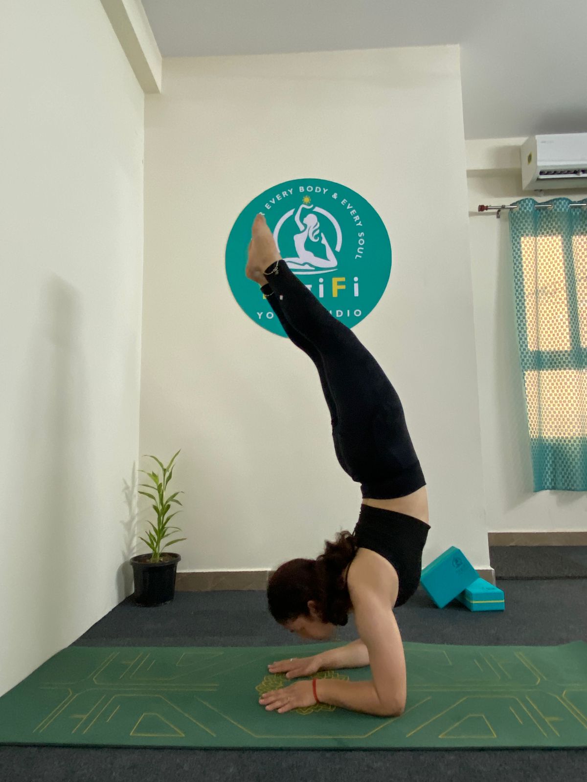 Bright and airy main yoga practice area at YogiFi, ready for a new class.
